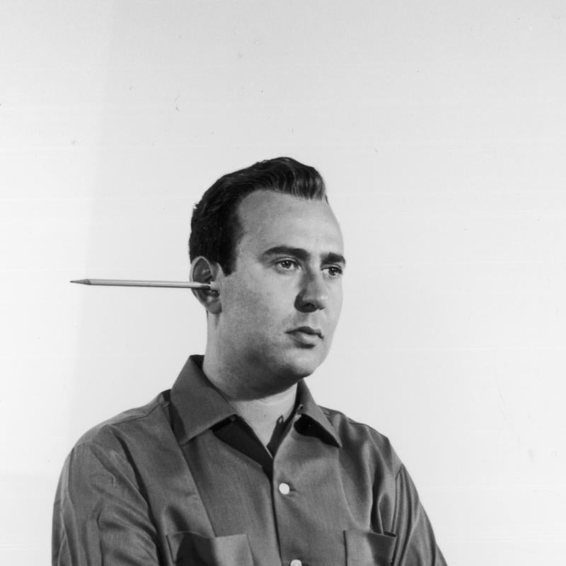 Comedy legend Carl Reiner poses with a pencil sticking out of his in 1955