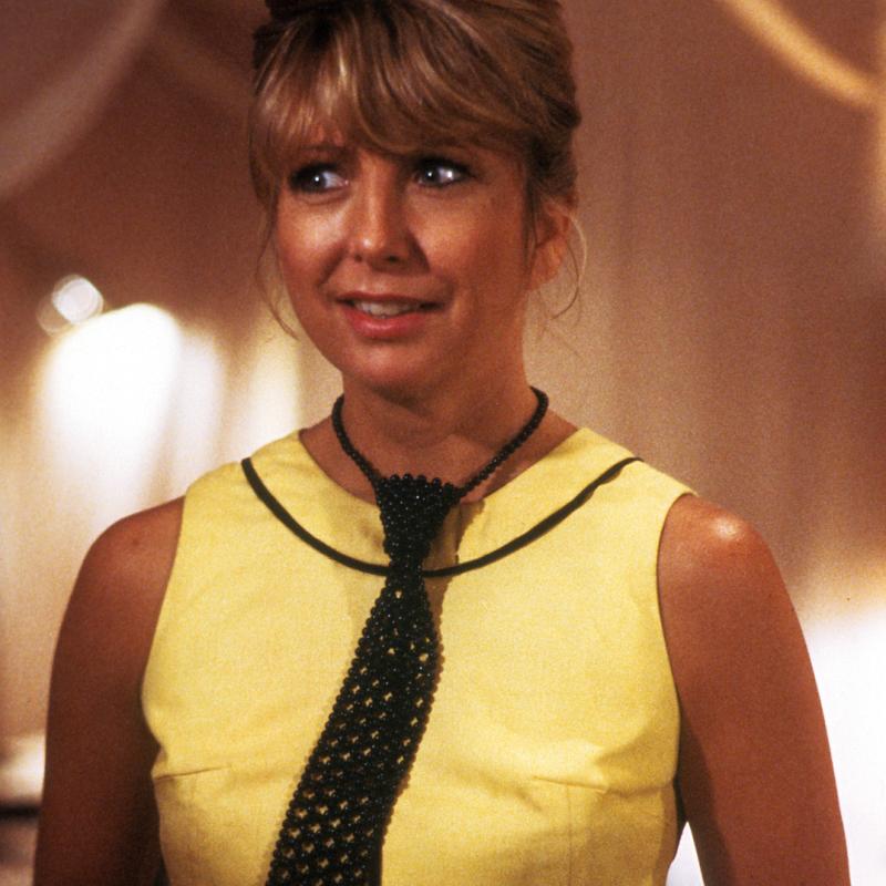 Teri Garr in a yellow dress with a black tie